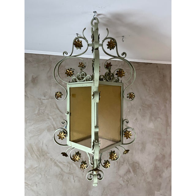 Add a touch of timeless elegance to your home or patio with this beautiful, classic-style wrought iron hanging lantern....