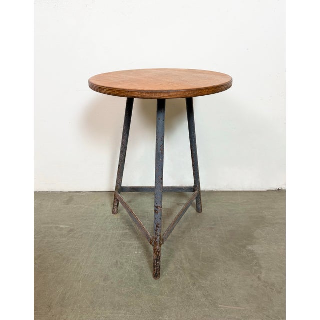 Vintage Industrial factory stool made in former Czechoslovakia during the 1960s It features a plywood seat and a grey iron...
