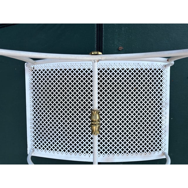 Classic mid century Hollywood regency style curved patio bench with perforated clover-patterned design on the seat....