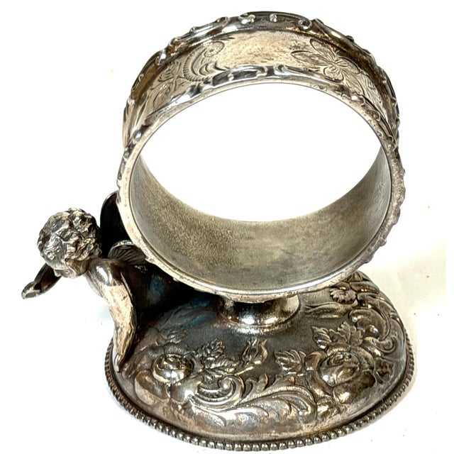 Victorian Figural Winged Cherub Silverplate Napkin Ring by Wilcox Silver Plate Co., Late 19th Century Dimensions: 2.75" H...