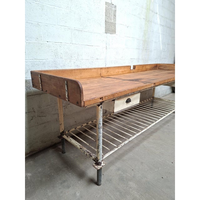 Original industrial baker's table with a solid beech wood top and white steel base. The worktop has been refinished with...