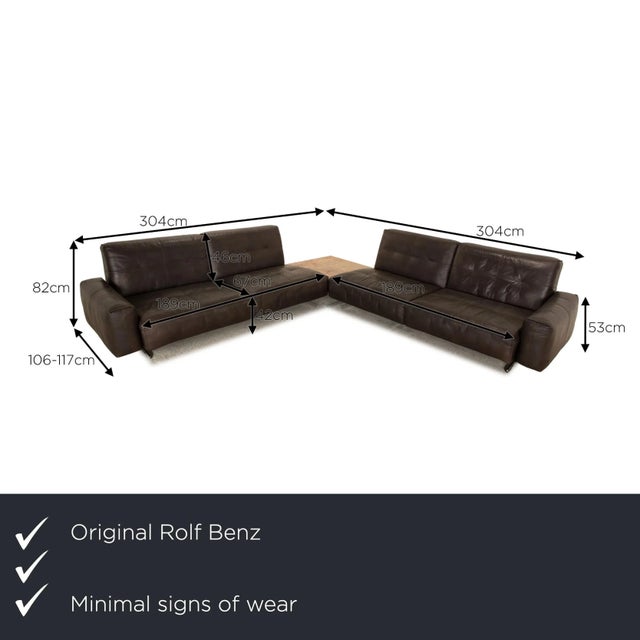 The corner sofa 50 by Rolf Benz is covered with a dark brown real leather and stands on black metal feet. It is...