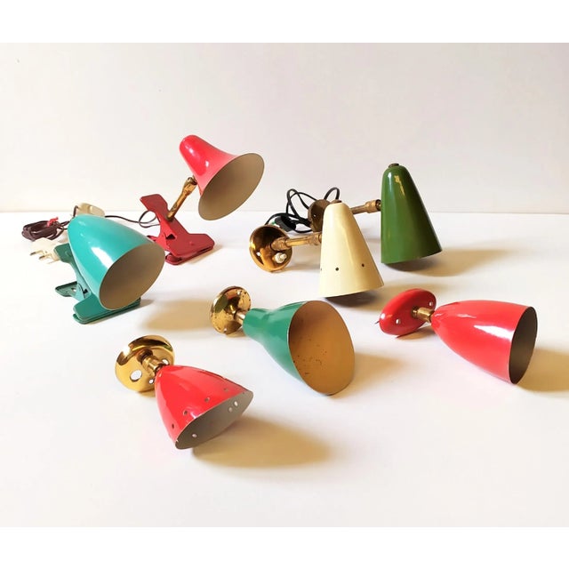 The spotlights are attributed to Gino Sarfatti and Angelo Lelii. The green spotlight is published in the Sarfatti...