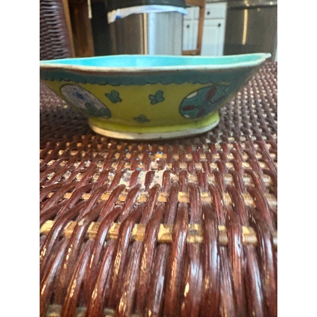 This is an antique Chinese porcelain footed bowl, potentially from the Qing Dynasty, decorated with famille rose...