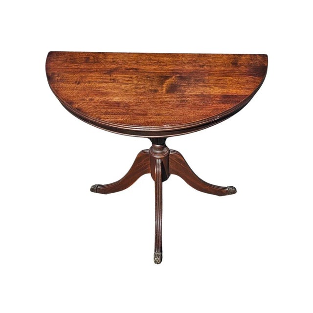 Early 20th Century Federal Mahogany Pedestal Trifid Demilune Table with brass paw feet. Measures 25" in width, 13" in...