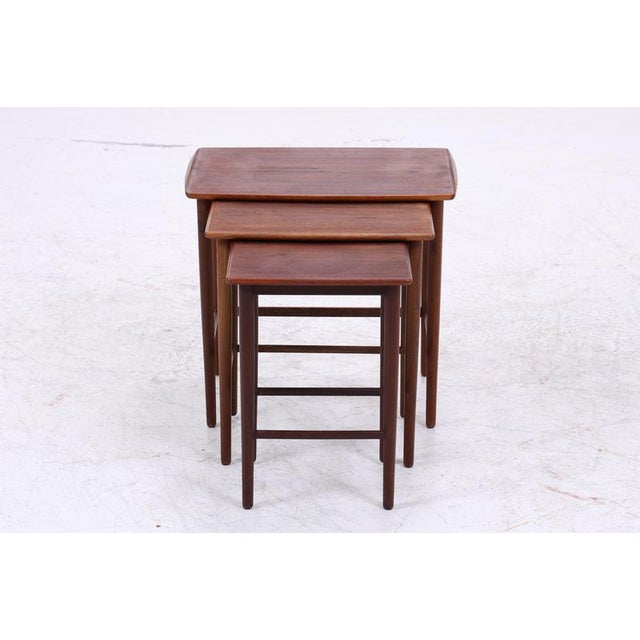 Vintage teak nesting tables with a clean, typically Danish design. The three tables can be nested together to save space...