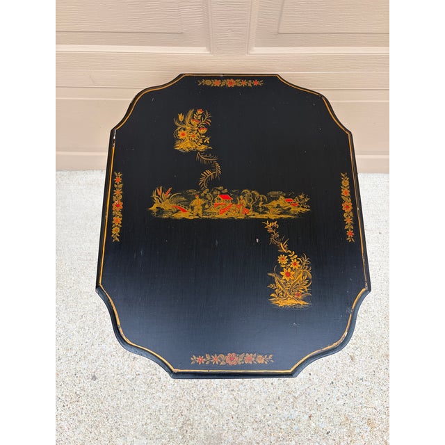 An elegant Regency-style Chinoiserie side table in painted walnut, featuring hand-painted gold and red decoration against...