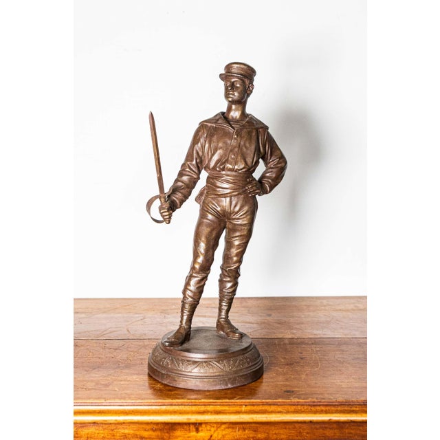 This early 20th-century French bronze trophy beautifully captures the elegance and athleticism of fencing, featuring a...