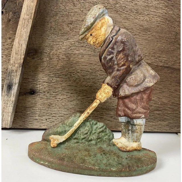 This decorative fine cast iron door stop of a primitive Golf Player is in original painted surface in beautiful colours,...