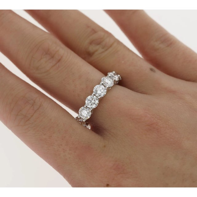 This wedding band ring features a prong setting of 15 round cut diamond stones. Each stone with own GIA certification. The...