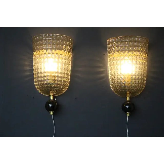 This pair of wall lights was made in Murano. They feature diamond cut in smoked textured Murano glass , looking like a...