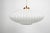A sculptural vintage pendant attributed to Louis Kalff for Philips, combining a broad ribbed glass shade with a warm...