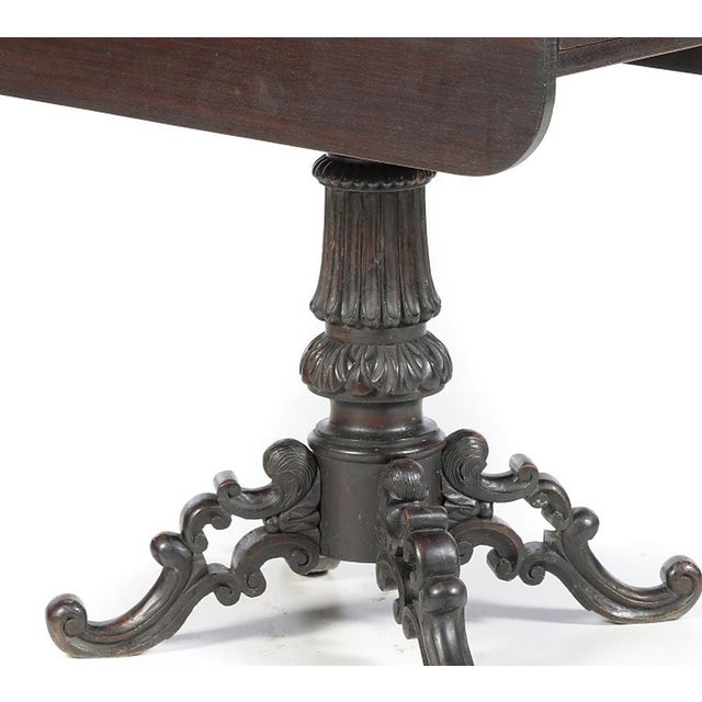 19th-century Portuguese Noble Wood sofa table; made of Noble Wood; box with one drawer simulating two. Rests on a carved...