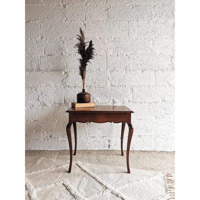 This oak coffee table features typical Baroque elements and was made in Belgium in the 1950s. The legs/feet are finished...