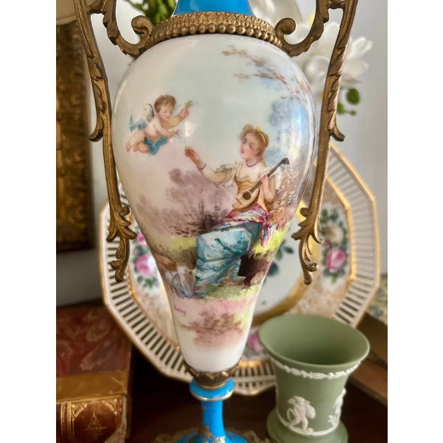 A striking antique Sèvres style hand-painted porcelain vase featuring a beautiful bleu céleste ground with delicate gilt...