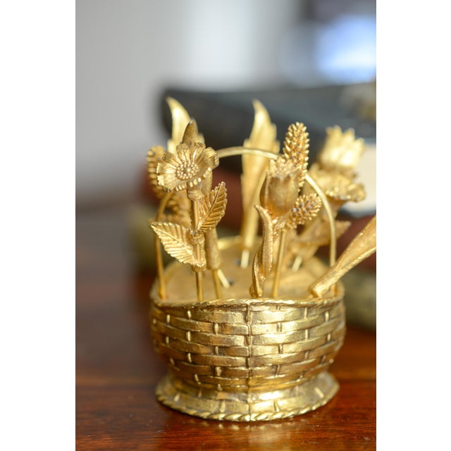 A charming mid-century Hollywood Regency cocktail pick or toothpick holder fashioned as a woven basket and flower picks....