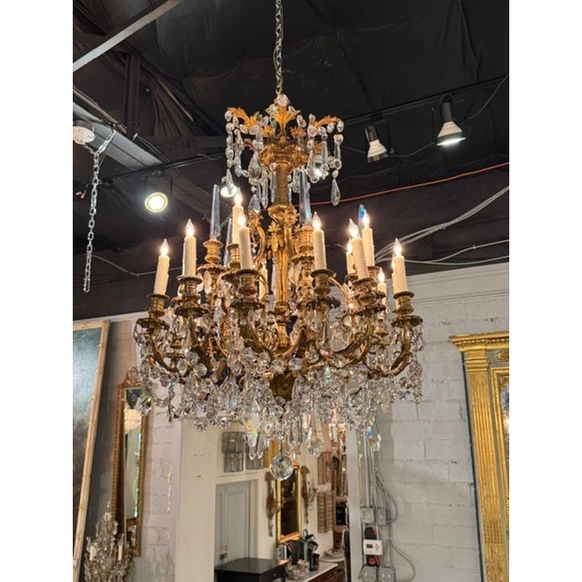 This luxurious 19th-century French gilt bronze and crystal chandelier is a stunning addition to any indoor space....