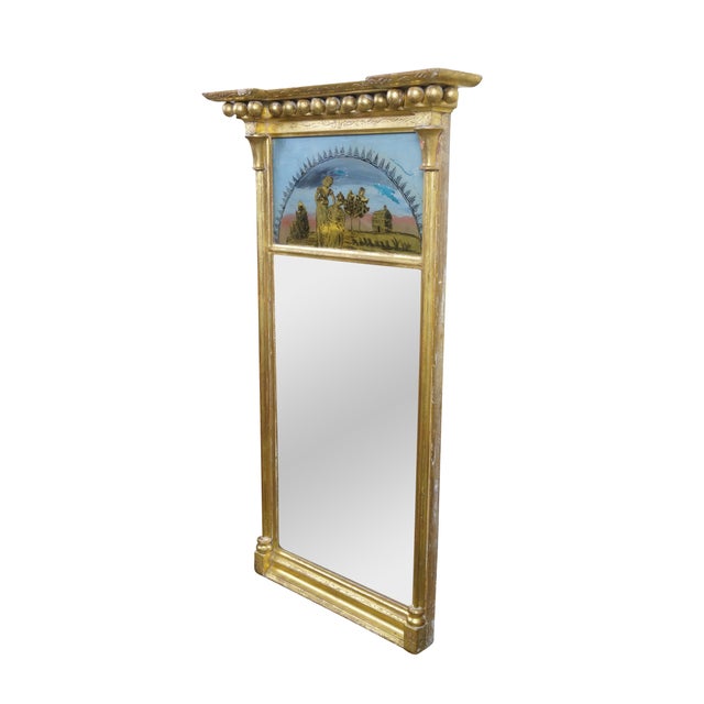 A fine Federal / Regency giltwood and gold gesso pier mirror. This antique mirror features an original Verre églomisé...