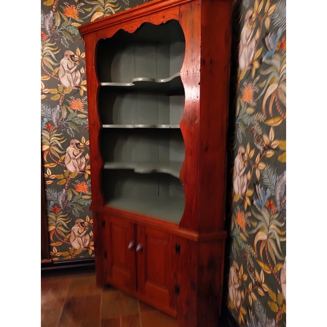 Beautiful solid American Pine corner display cabinet. The inside is a painted blue/tiel. The pulls are new and add a...