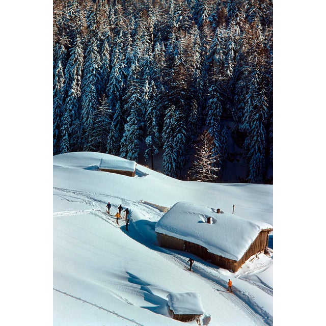 A Chalet In Winter by Toni Frissell A group of skiers pass a chalet at the St. Anton ski resort, Austria, 1955. (Photo by...