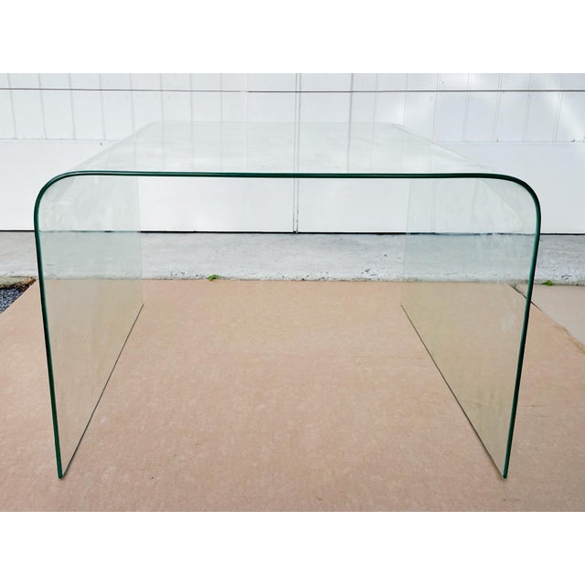 A glass "waterfall" coffee table or side table, crafted in Italy, in the style of Angelo Cortesi who designed modern glass...
