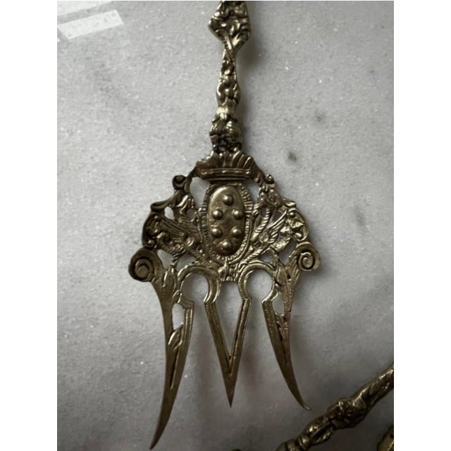 vintage Italian Baroque-style serving set features an ornate, pierced brass fork and spoon crafted in Italy, frequently...