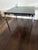 Black Marble Side or Coffee table on a polished chrome base originally designed by Florence Knoll in 1954 and produced by...