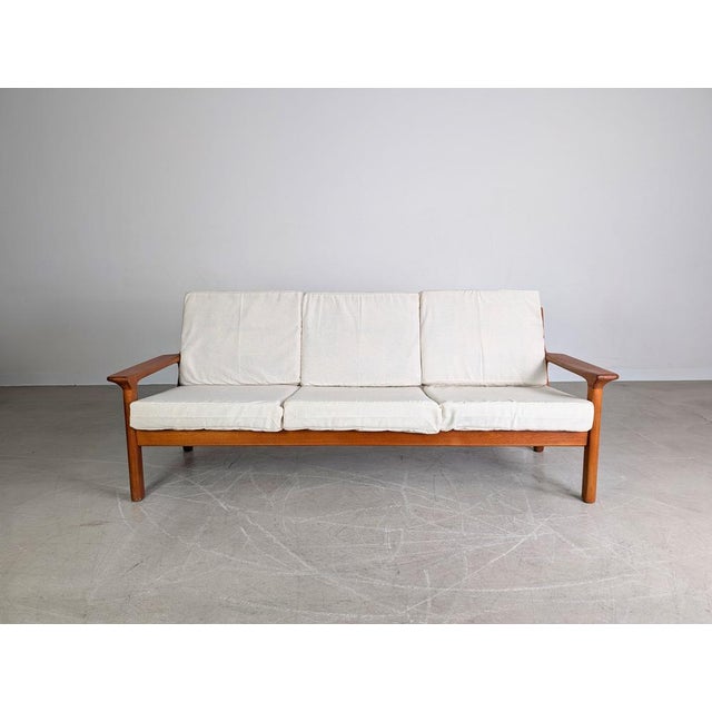 We are offering for sale a beautiful vintage three-seater sofa from the traditional Danish manufacturer Glostrup...