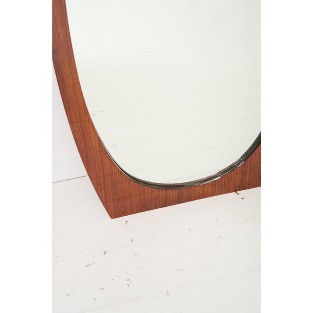 Teak mirror by gianfranco frattini, circa 1970s. Rectangular teak frame, oval mirror. Very good condition, with some signs...