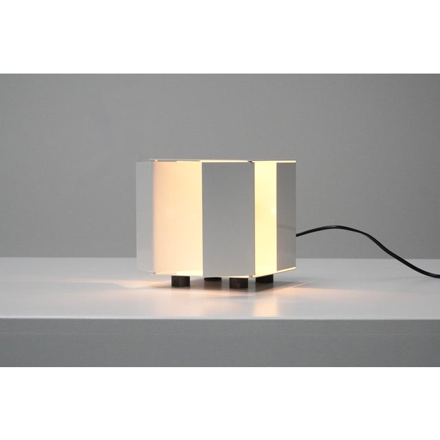 Very rare cubic-shaped table lamp, designed by Paolo Tilche for Sirrah in 1970s Italy. The lamp features four removable...