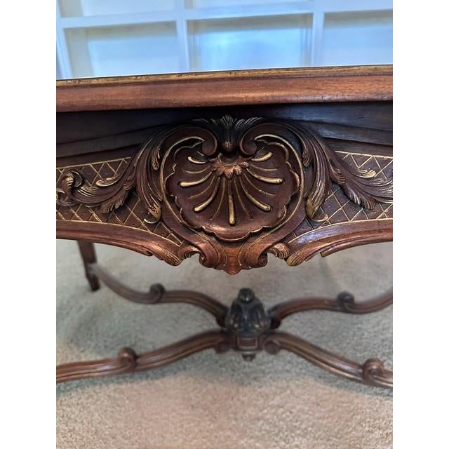 This elegant French Louis XV style table features sophisticated cabriole legs and intricate hand carved rococo detailing,...