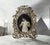 Victorian-style ornate brass oval picture frame is most likely a mid-to-late 20th-century typically manufactured between...