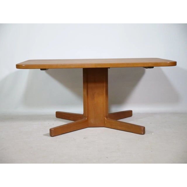 1960s teak dining table by KP Møbler, Danish design. Made of solid teak, with a rectangular tabletop and central base. The...
