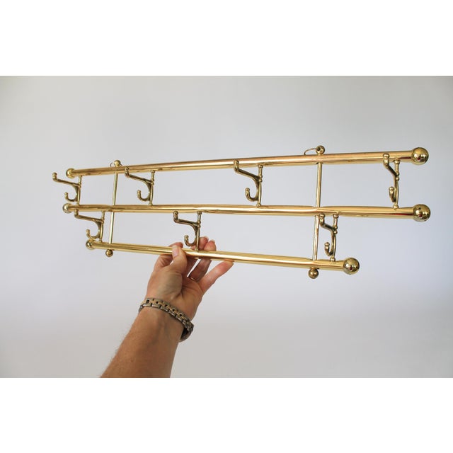 Vintage brass plated coat & hat wall mounted rack. No makers mark. Some light age wear to brass plate finish.