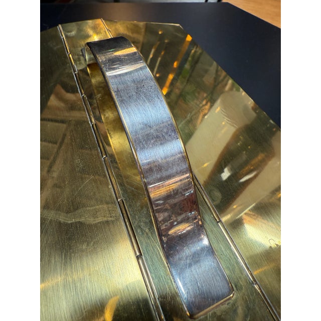 Striking mid-century modern rectangular box crafted from polished brass and steel, featuring a hinged lid with a curved...
