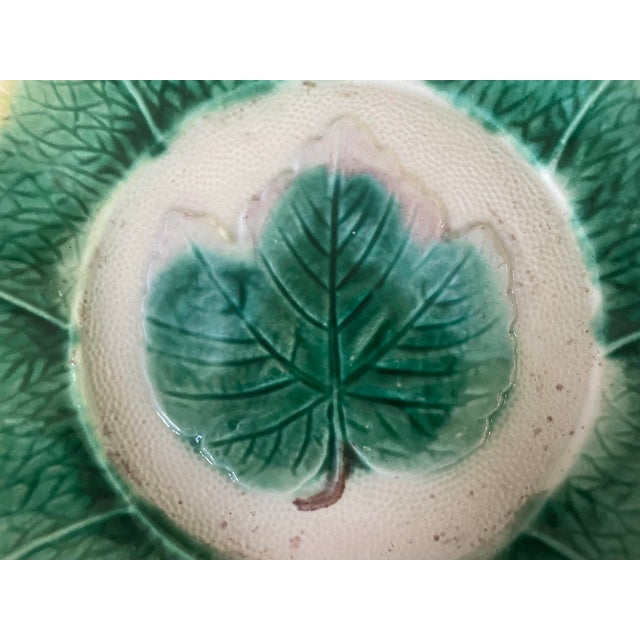 Vintage majolica decorative bowl. The bowl features a large leaf in the center in green, yelloow and brown on an ivory...