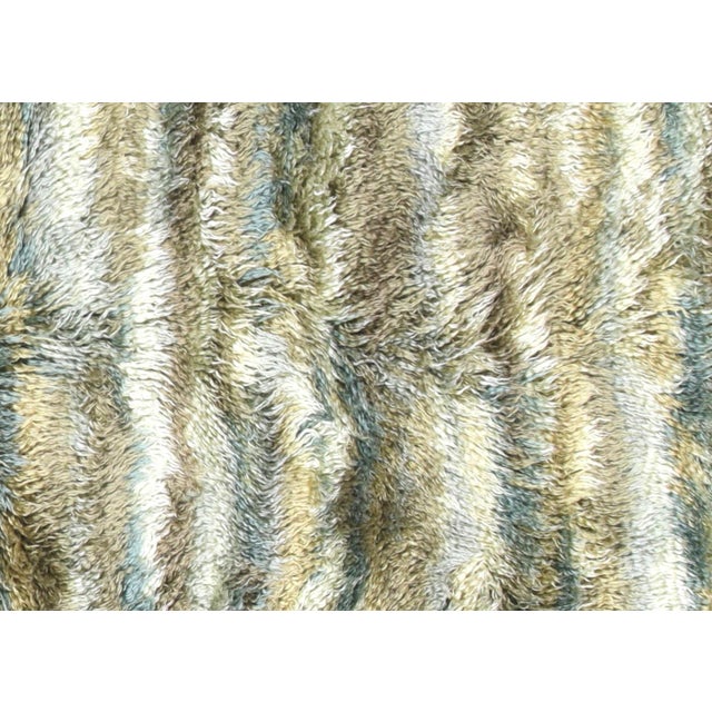 This vintage Turkish shag rug, measuring 6'2" by 8'2", is handwoven in the Oushak region of Western Turkey using a blend...