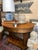 Antique early 1900s library table. Distinctive oval shape with double pedestal base, lower display shelf, and single...