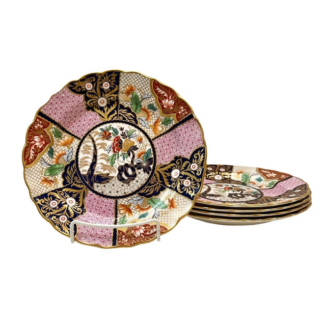 A set of four Imperial Stone china plates by John Ridgeway. Highly decorated in pink, gold and black with paneled with...