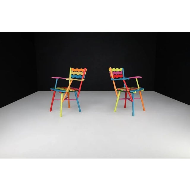 Pair of Mid-Century French Folk Art Painted Beechwood Armchairs, France, 1960s A captivating pair of Mid-Century French...