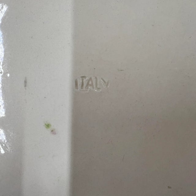 Vintage Italian floral plate. Measures 10.5” diameter x 1” h. Ivory background with green pink, purple, yellow and blue...