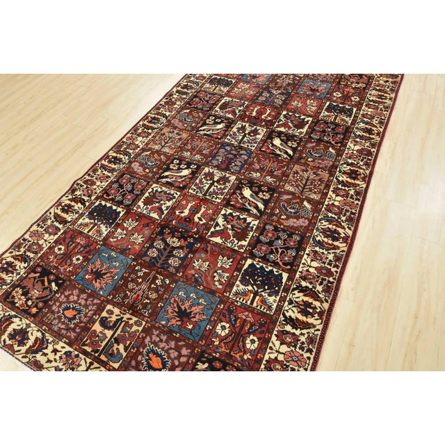 An authentic, semi-antique, traditional tribal Bakhtiari rug, hand-knotted with fine wool and natural dyes. This oriental...