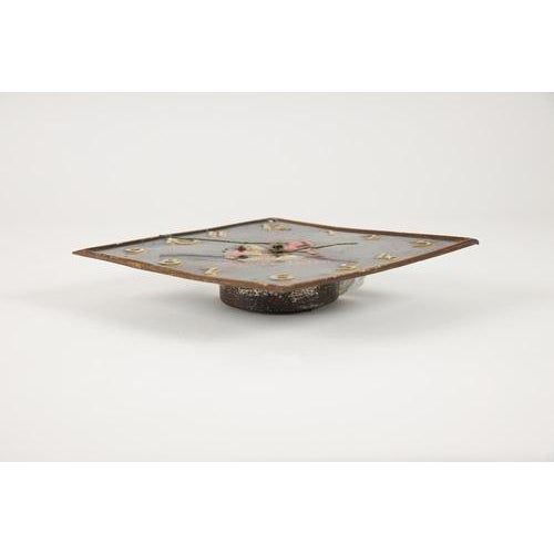 Promotional clock from the super iride paint company, rhomboid-shaped, made of lithographed tin with a mechanical movement...