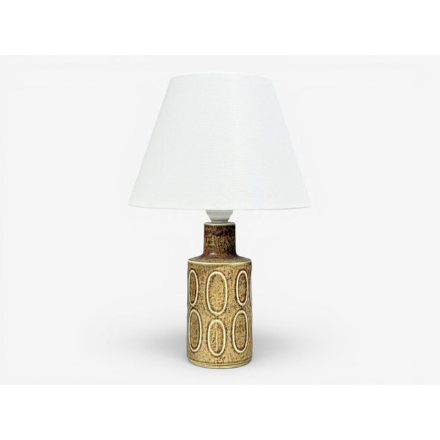 Desiree Stentöj, Danish Mid-Century Modern, Table Lamp, Brown Stoneware, Denmark, 1960s A brown glazed table lamp designed...
