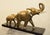 Elephant and his little one in regula with golden patina on black marble base signed Rochard. In very good condition with...