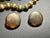 The standard spherical beads feature a heavy fine-line brushed or satin finish etched directly into the gold-tone metal....