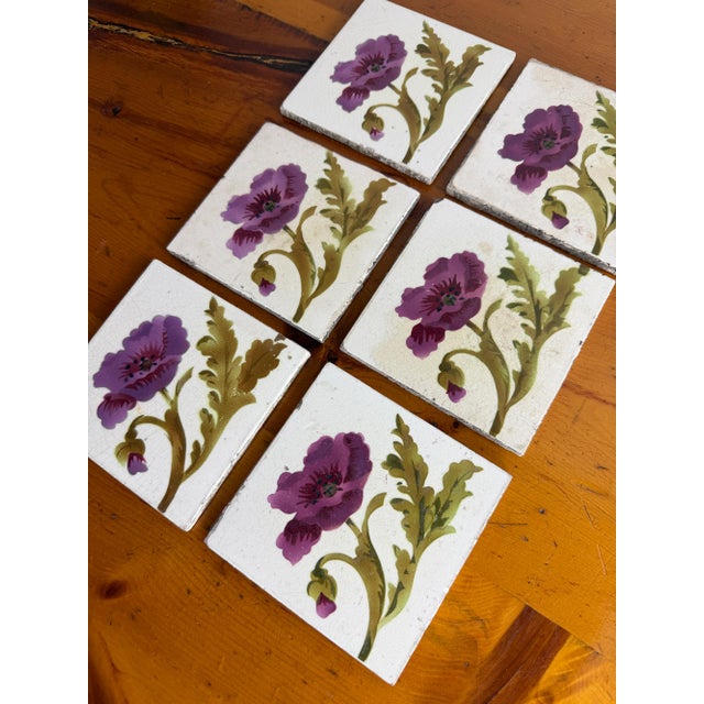 Set of six antique French Art Nouveau ceramic tiles, each hand-painted with an elegant pink poppy and flowing green...