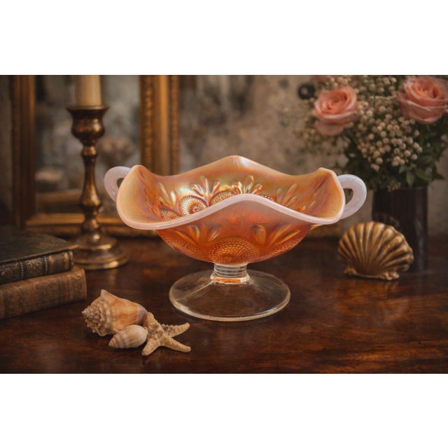 This beautiful antique carnival glass compote was produced by the Dugan Glass Company of Indiana, Pennsylvania, one of the...