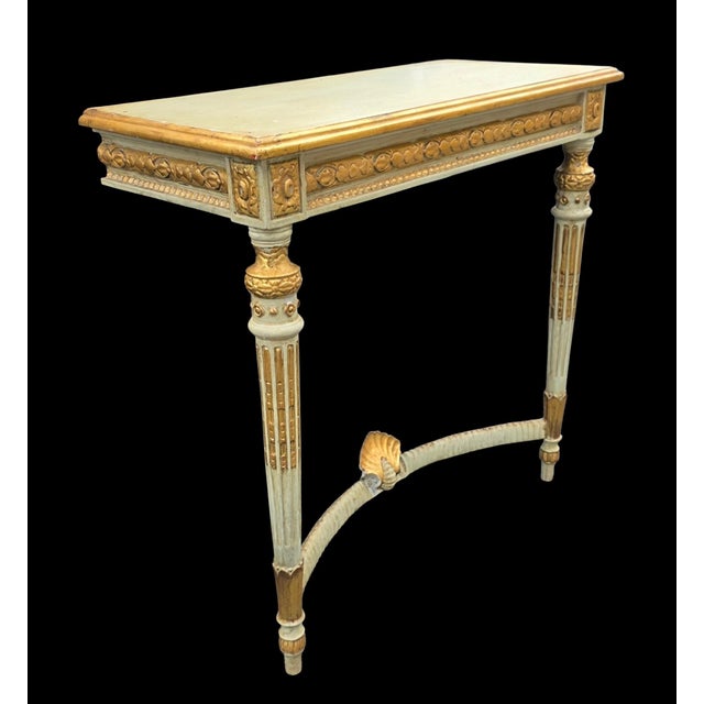 A distinctive French Louis XVI Revival console table, dating to the late 19th century, executed in an elegant ivory-...
