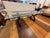 Design Plus Gallery presents a Contemporary Sculptural Trestle Wood & Glass Dining Table. This distinctive table pairs a...